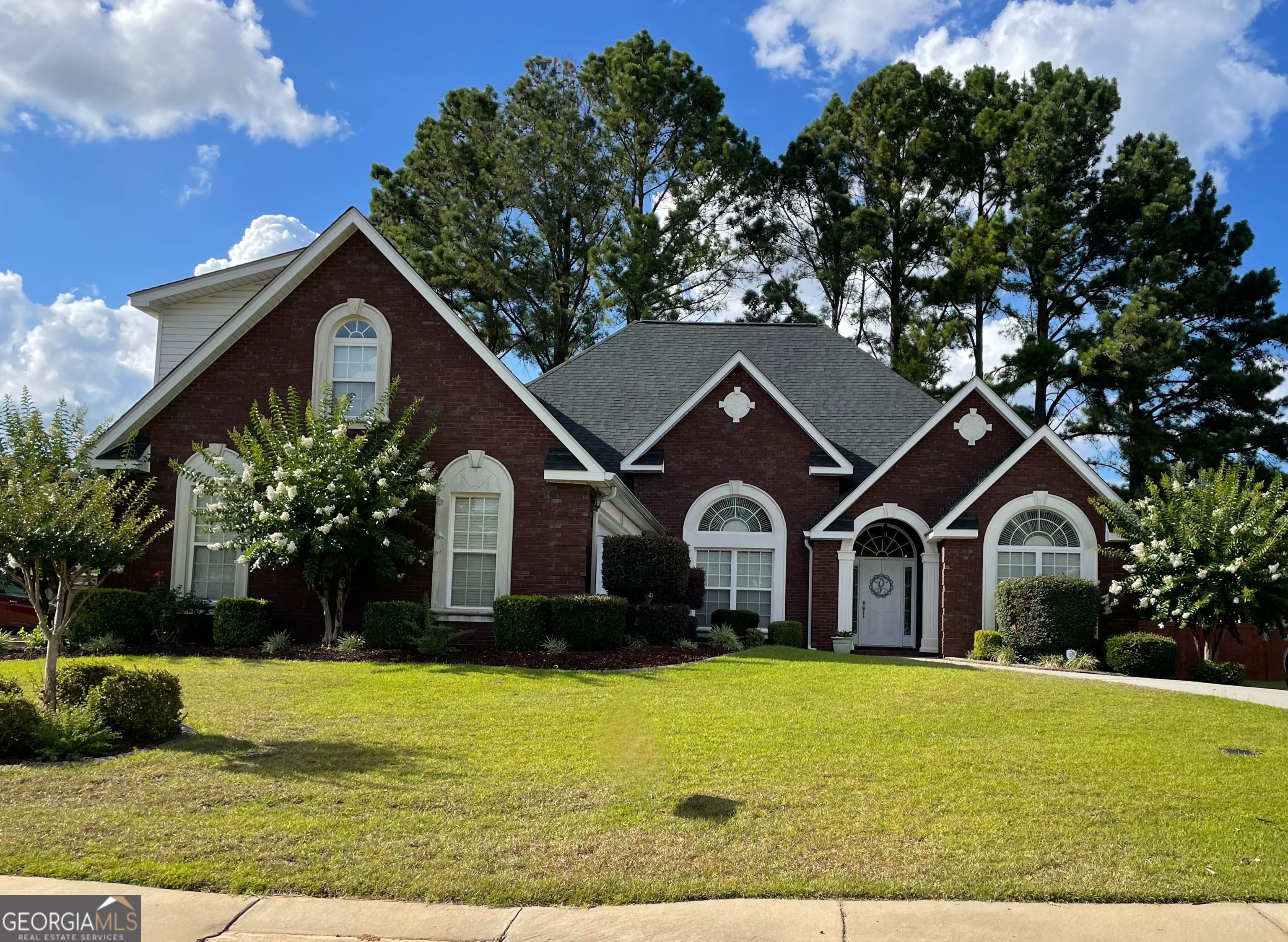 a front view of a house with garden