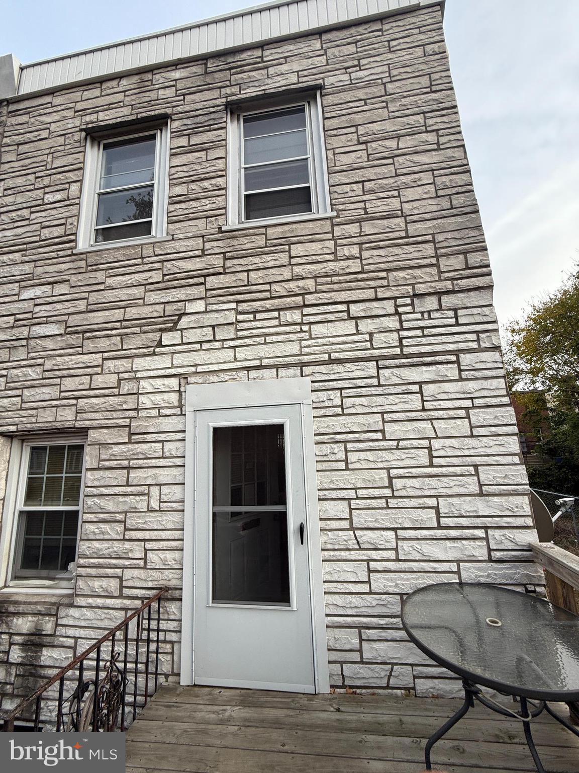 a brick house with windows on the deck