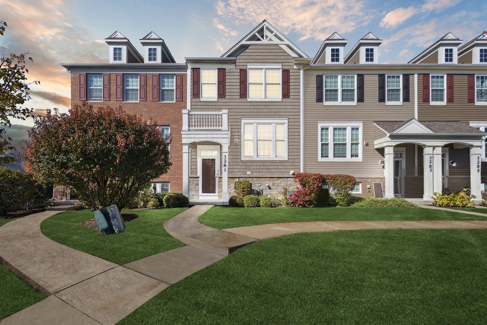 a front view of a brick house with a yard