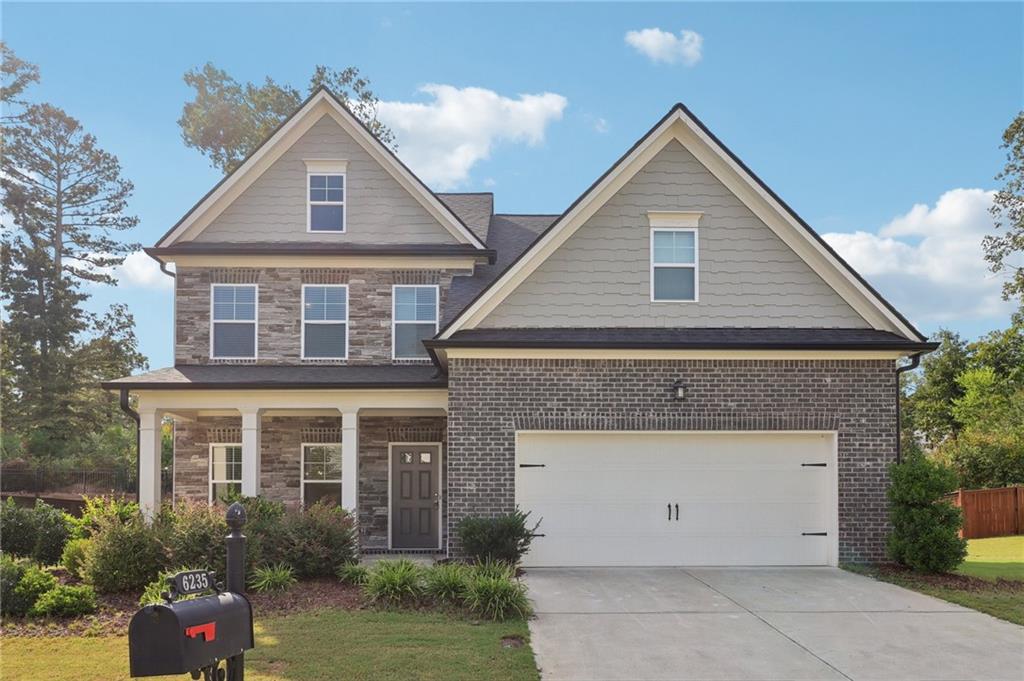 a front view of a house with a yard and garage