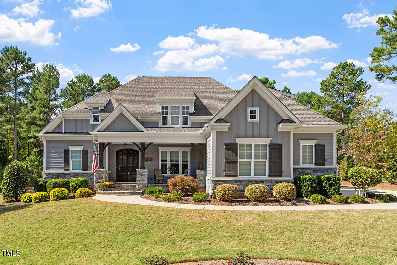 a front view of a house with swimming pool having outdoor seating