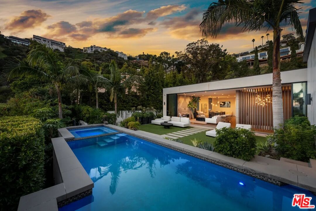 a view of swimming pool with seating space and garden