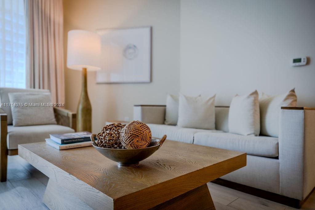 a living room with furniture and a lamp