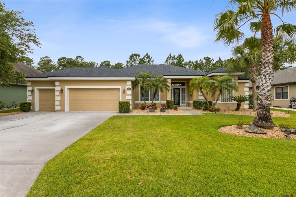 a front view of house with yard and green space