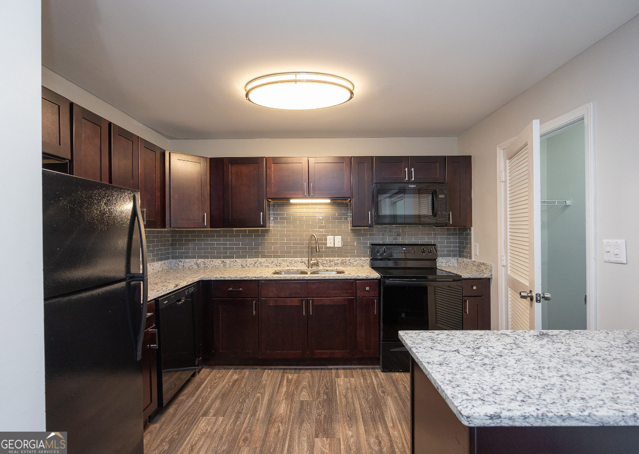 a kitchen with granite countertop stainless steel appliances and wooden cabinets