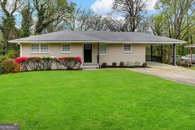 a front view of a house with a garden and yard