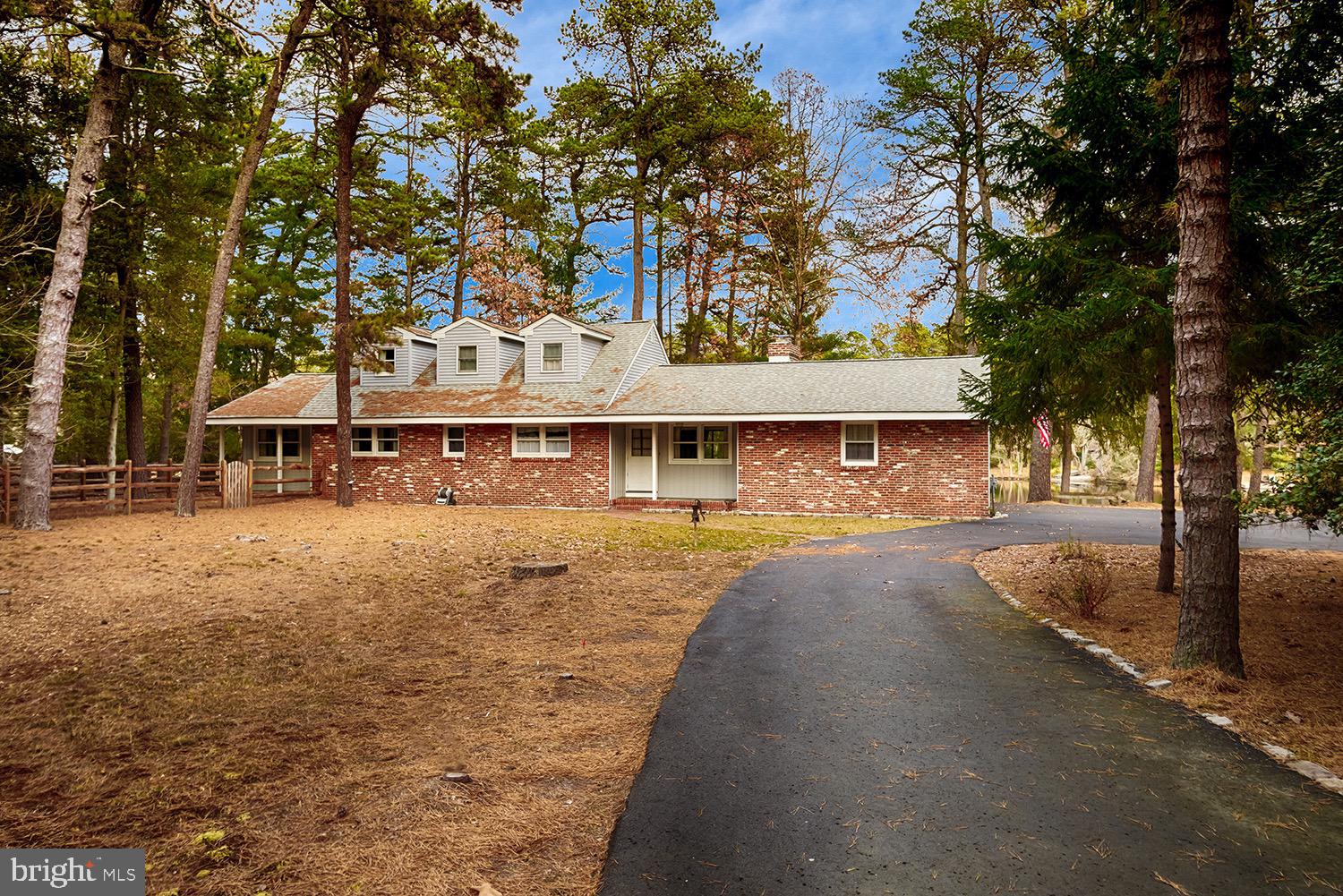 a front view of a house with a yard and tree