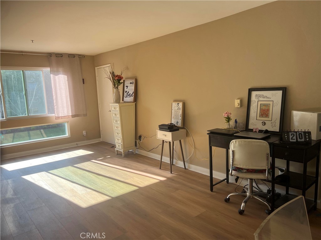 a view of a workspace with furniture and a window