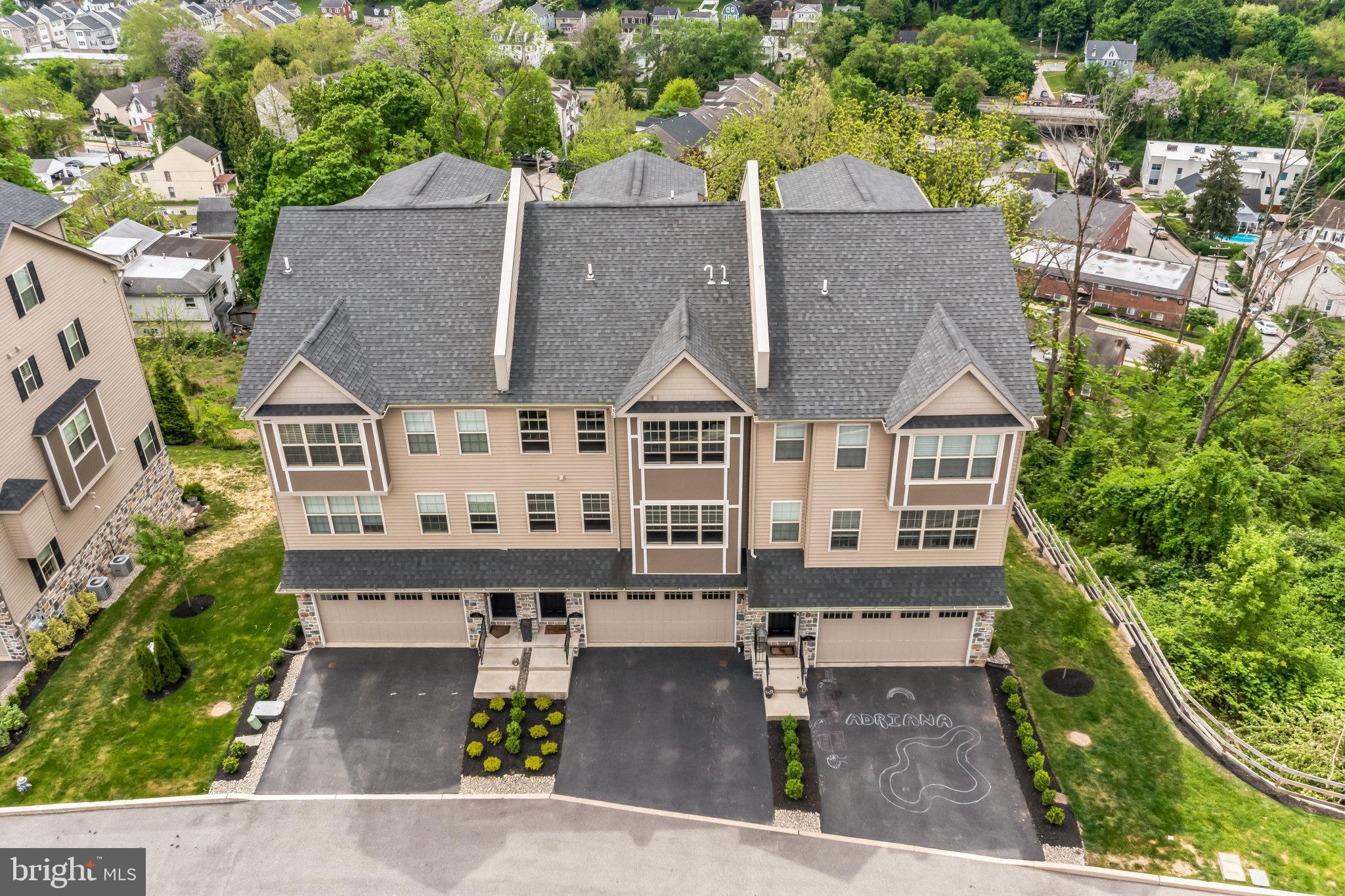 an aerial view of a house with swimming pool and sitting area