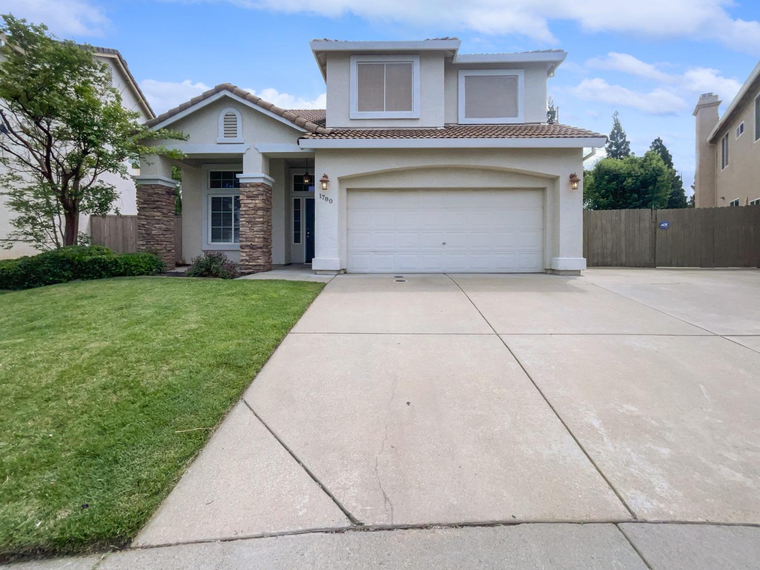 a front view of a house with yard