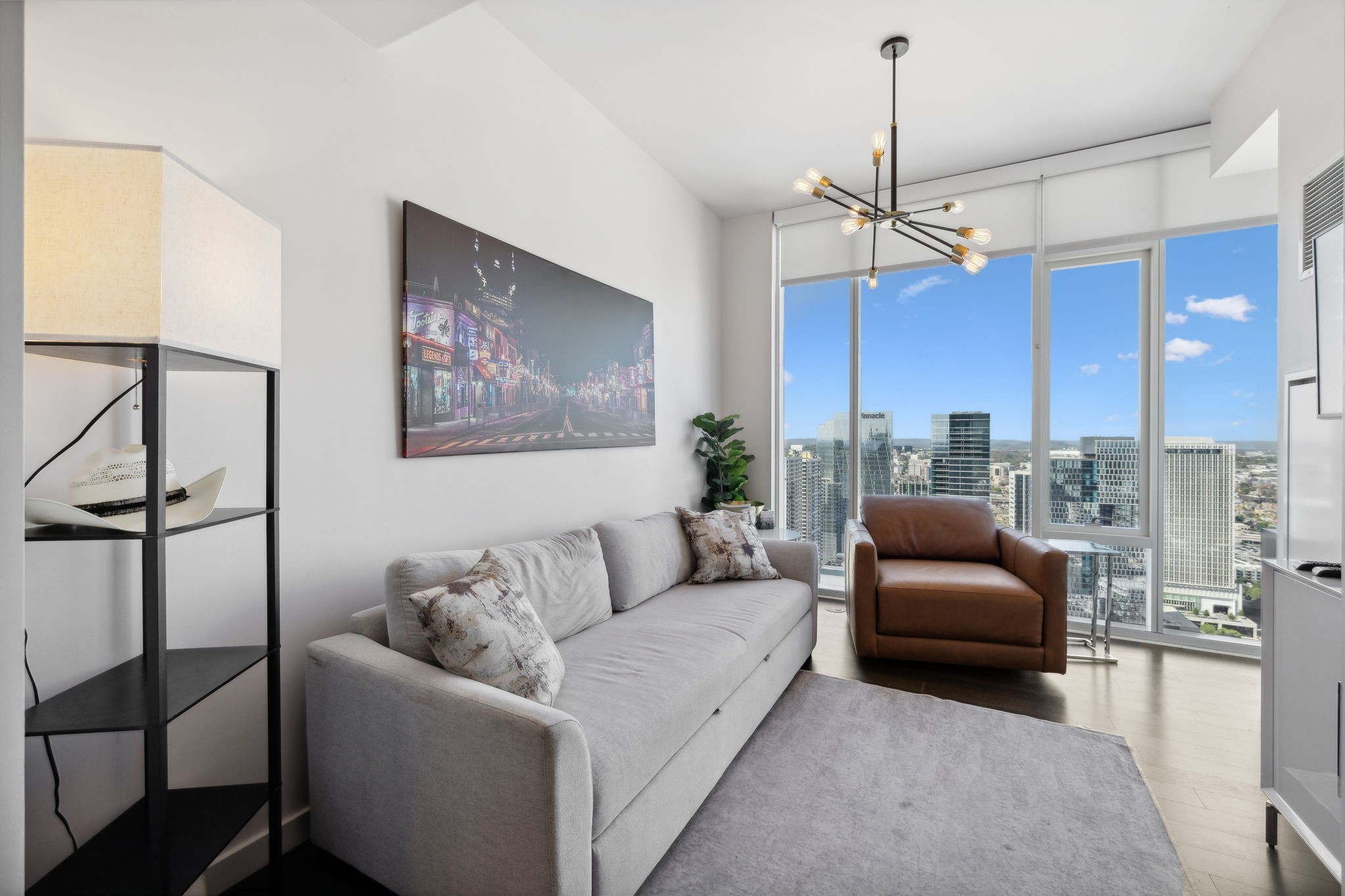 a living room with furniture a ceiling fan and a window