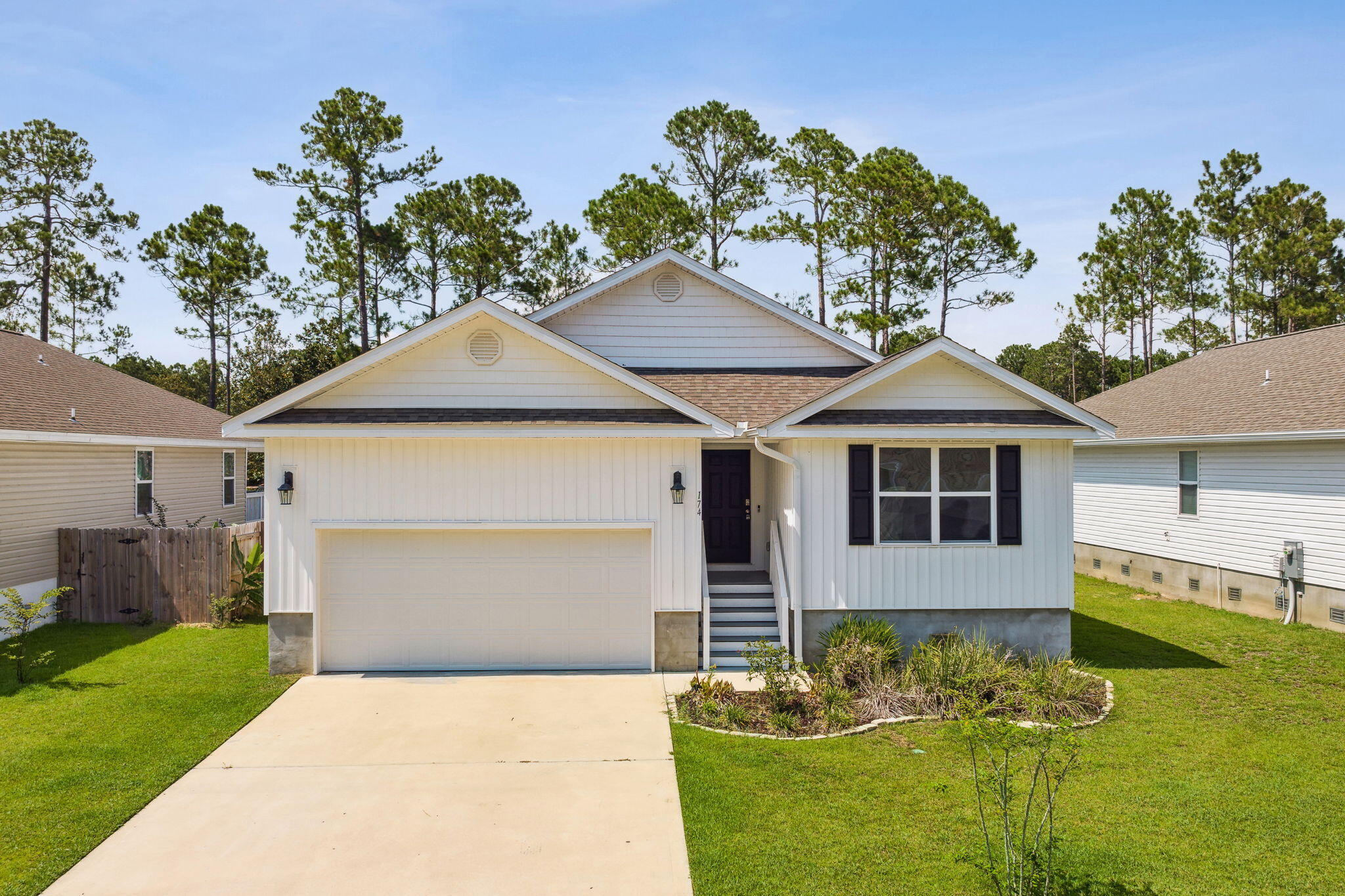 a front view of a house with a garden