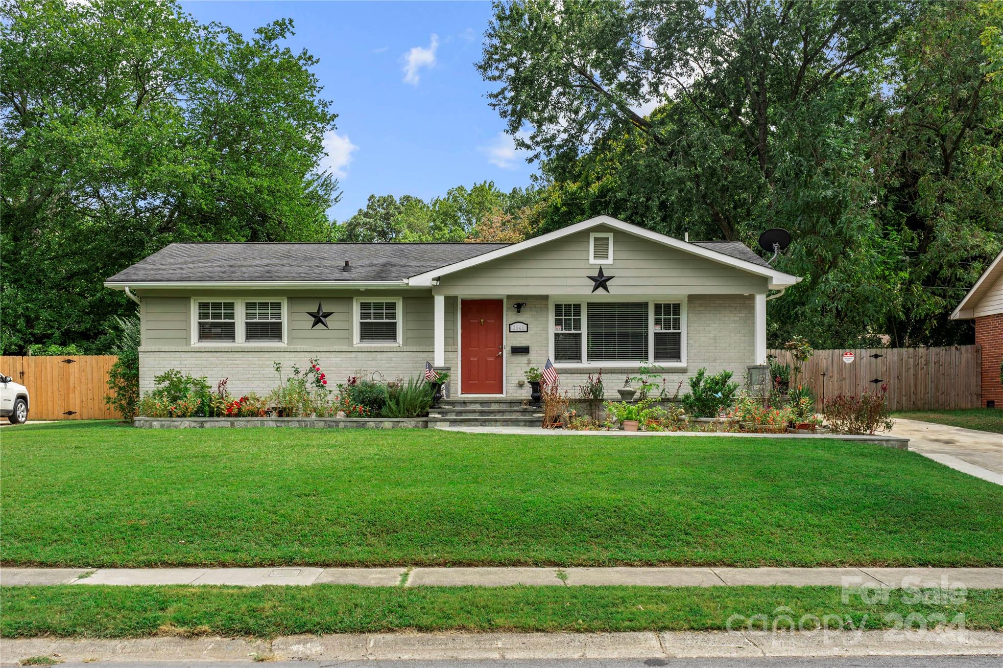 a front view of a house with a yard and porch