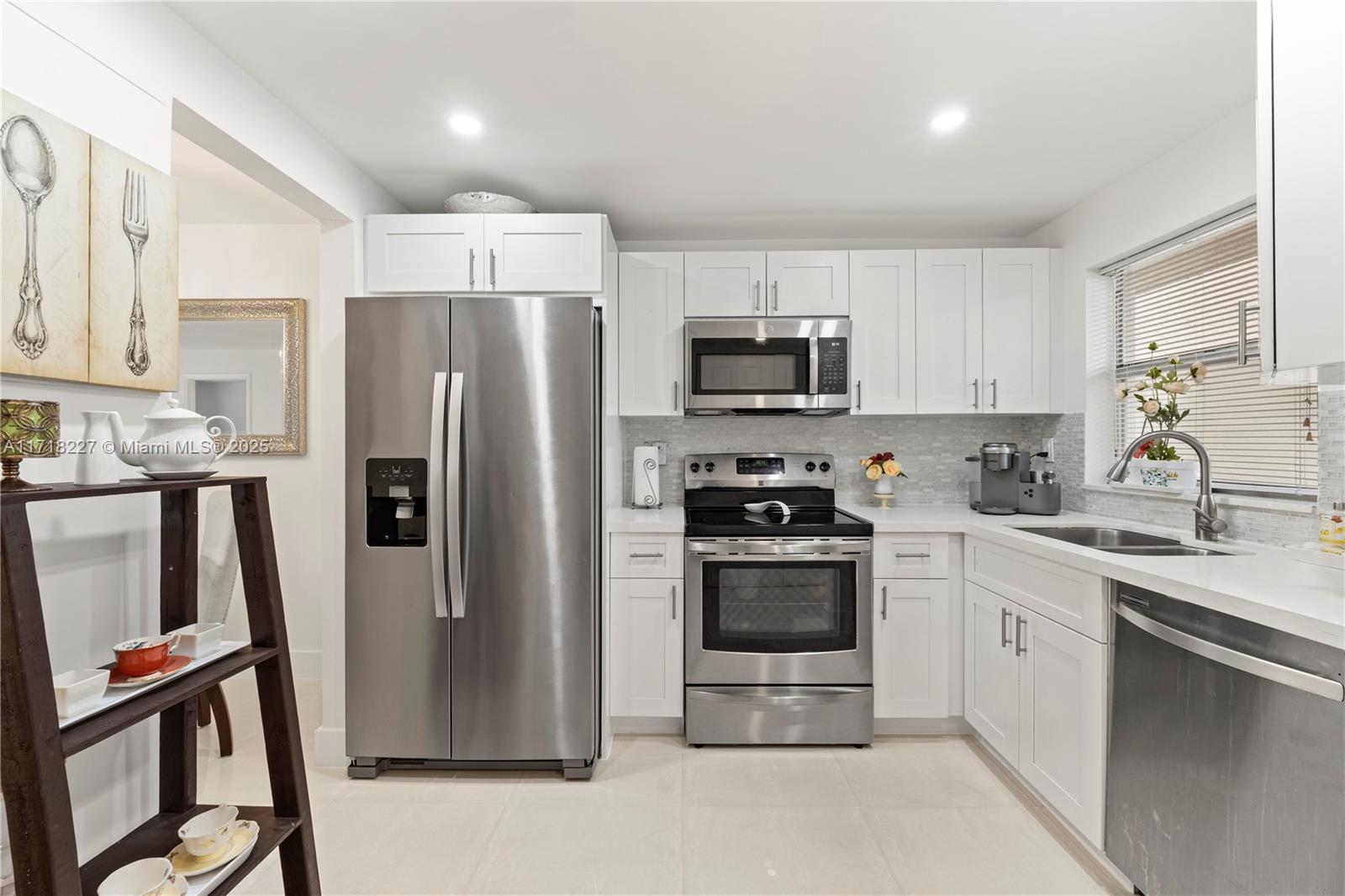 a kitchen with stainless steel appliances a refrigerator stove and sink