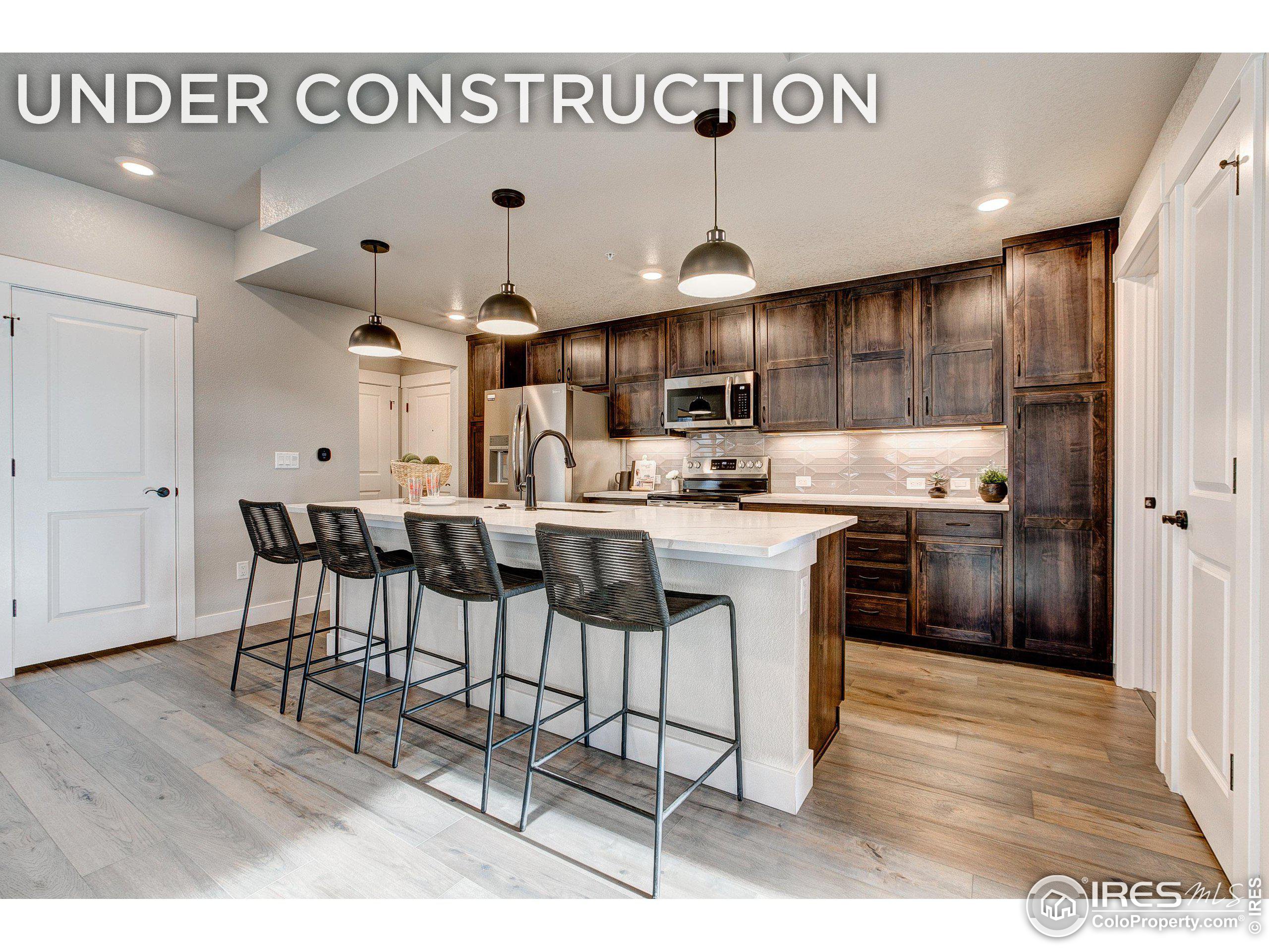 a kitchen with stainless steel appliances kitchen island granite countertop a sink and cabinets