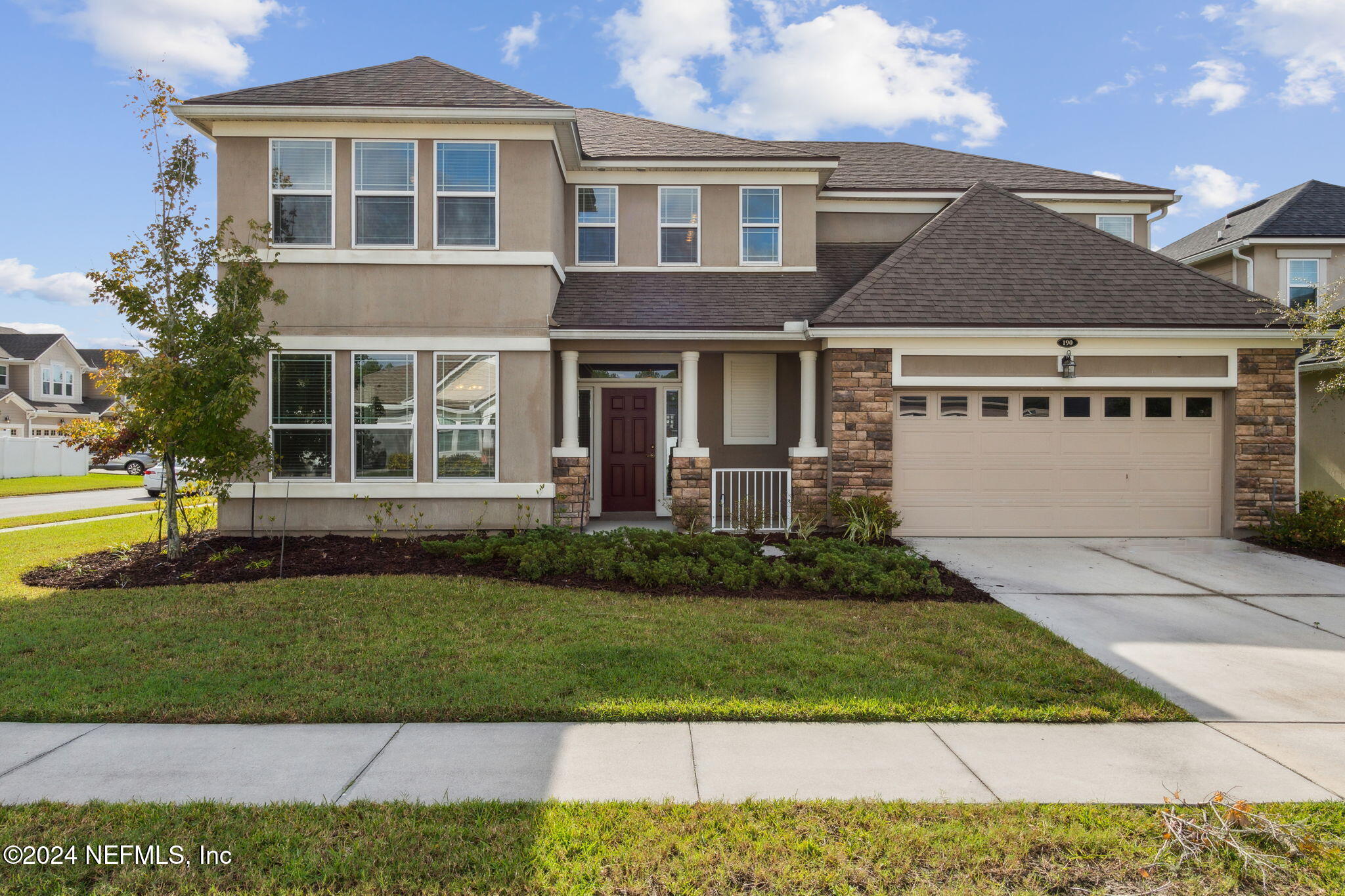 a front view of a house with a yard