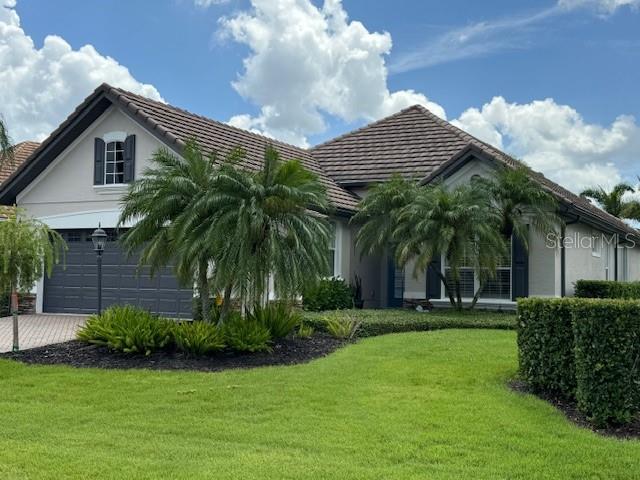 a front view of a house with a garden