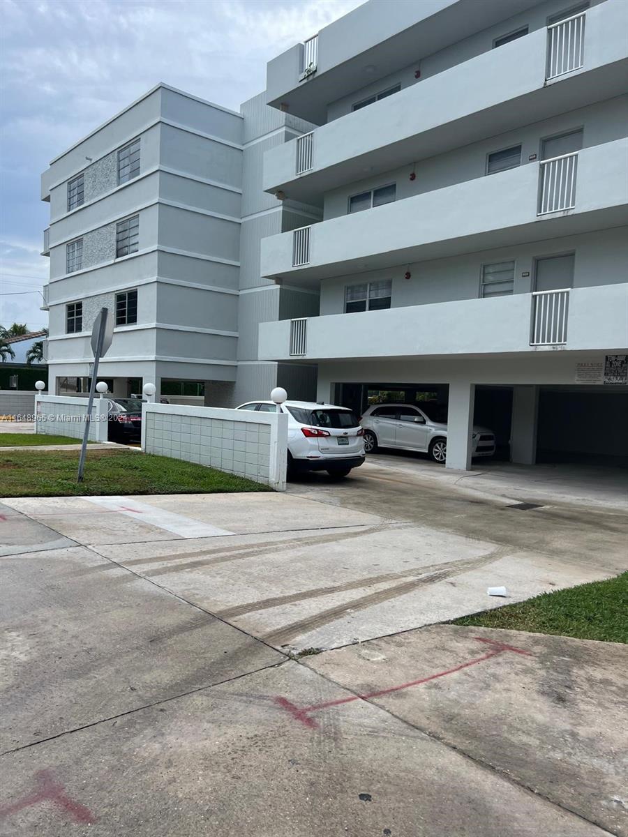 a view of building with car parked