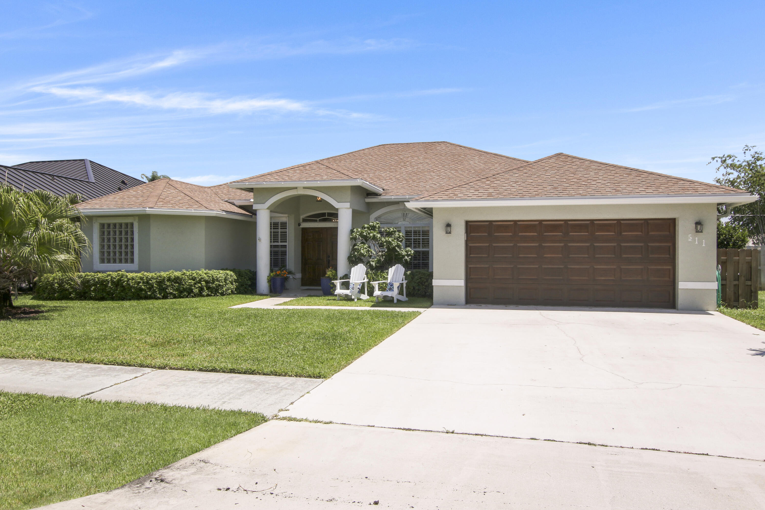 a front view of a house with a garden and yard