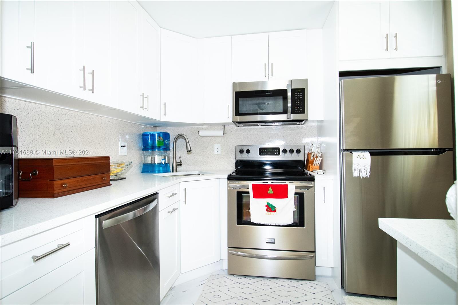 a kitchen with stainless steel appliances a stove microwave and a refrigerator