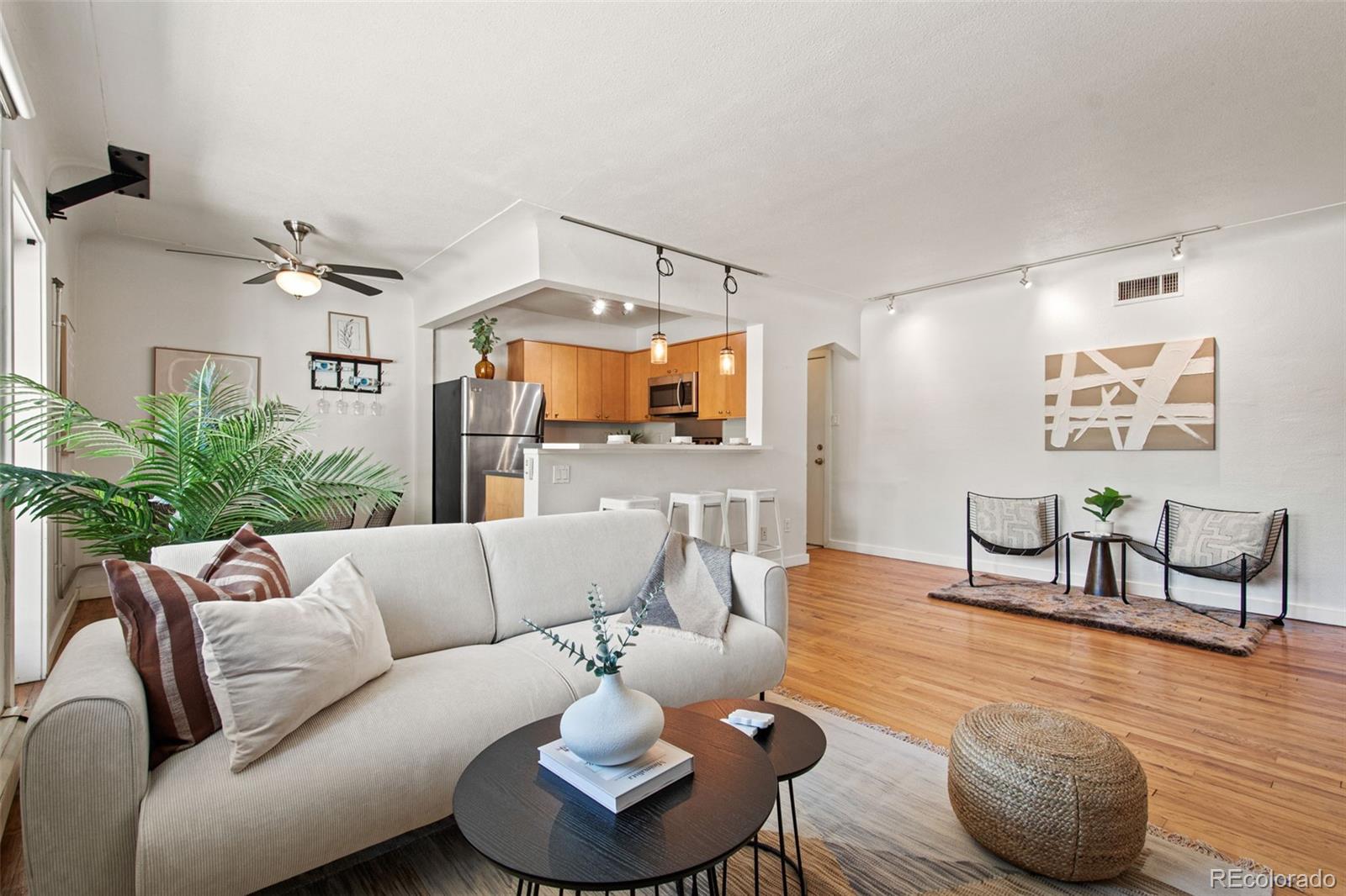 a living room with furniture and wooden floor