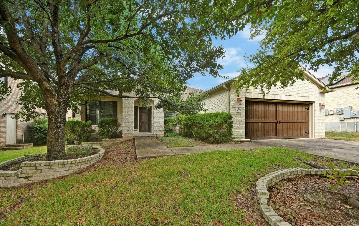 a view of a house with a yard and tree s