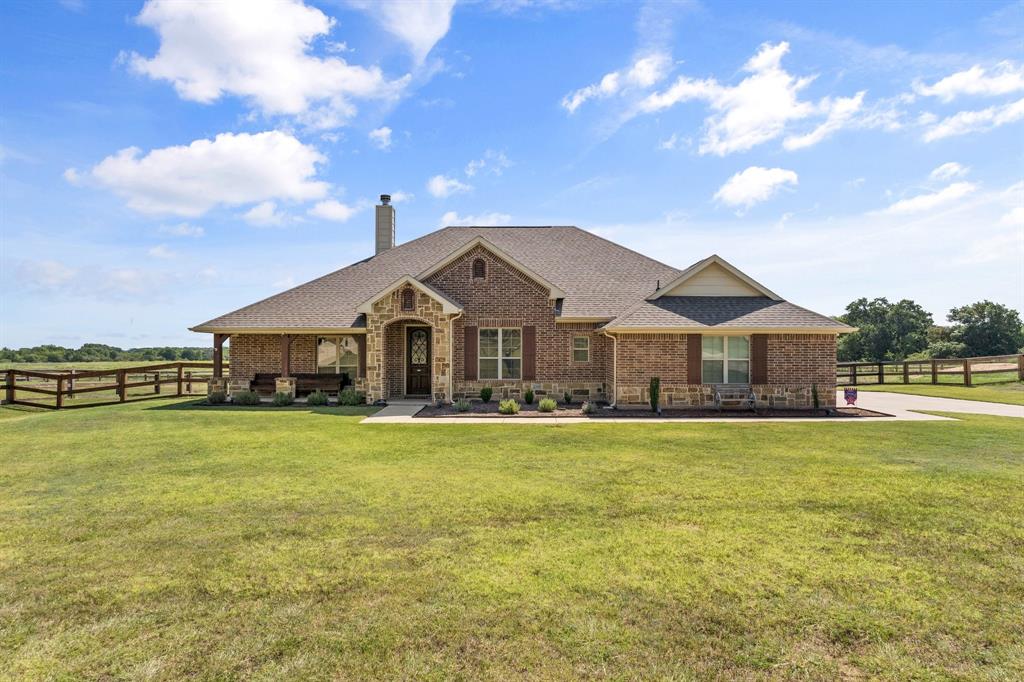 a front view of a house with yard swimming pool and outdoor seating