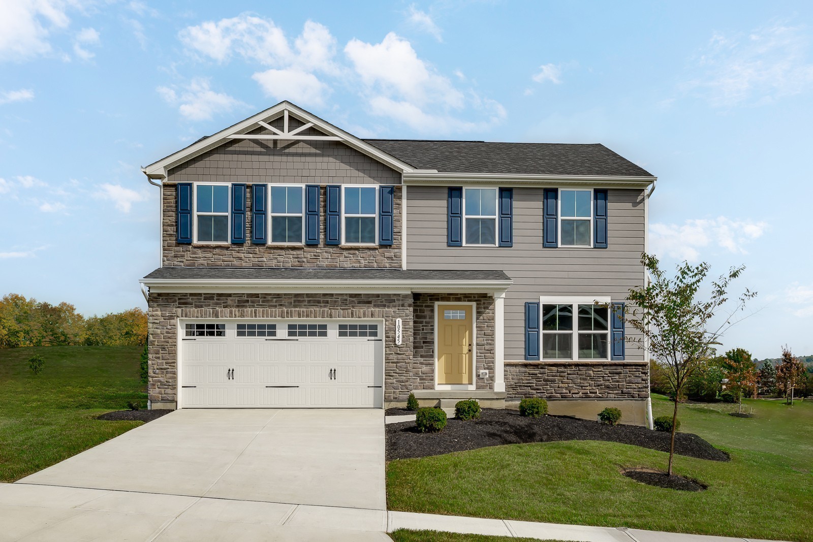 a front view of a house with a yard