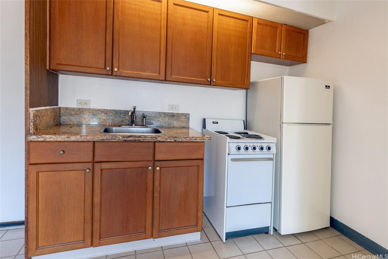 a kitchen with stainless steel appliances granite countertop a refrigerator sink and cabinets