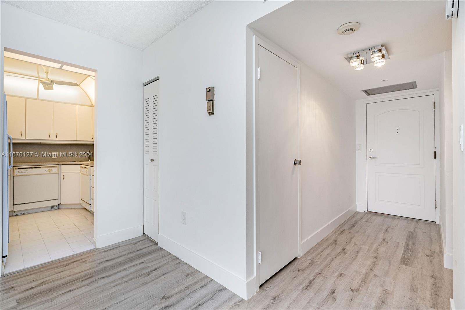 a view of hallway with wooden floor