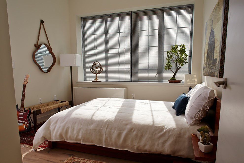 a bedroom with a bed and a window