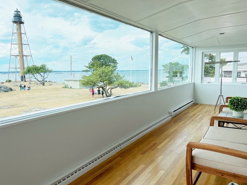 a room with a large window and wooden floor