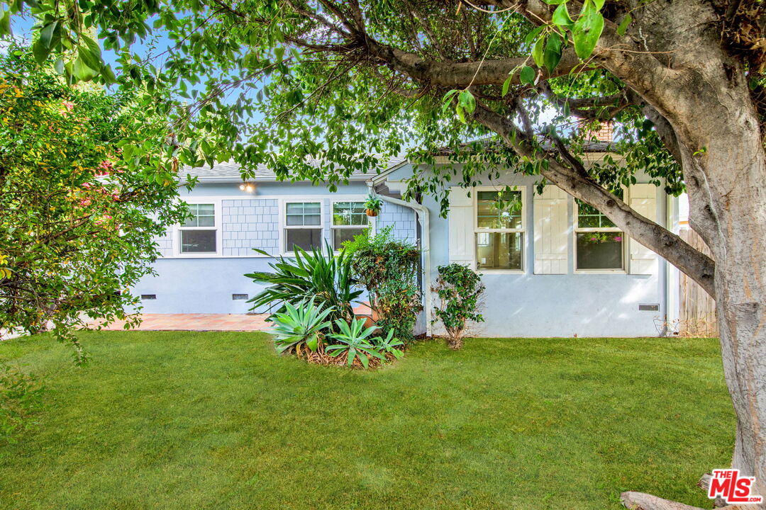 a front view of house with yard and trees