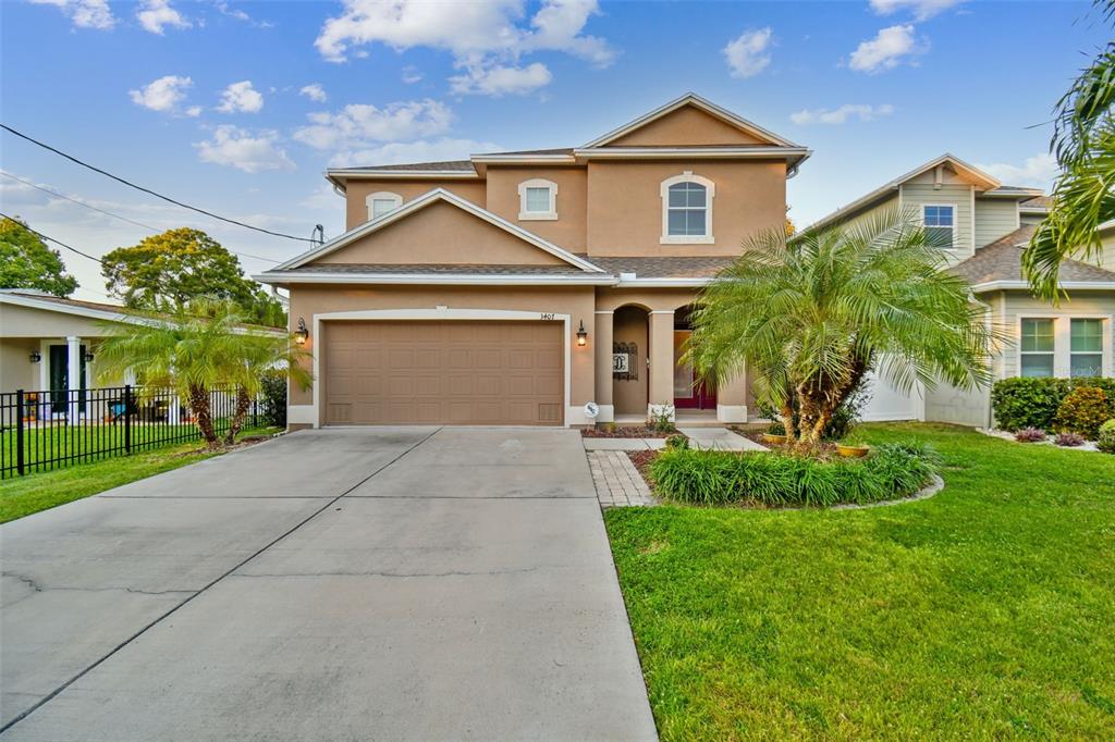 a front view of a house with a yard and garage