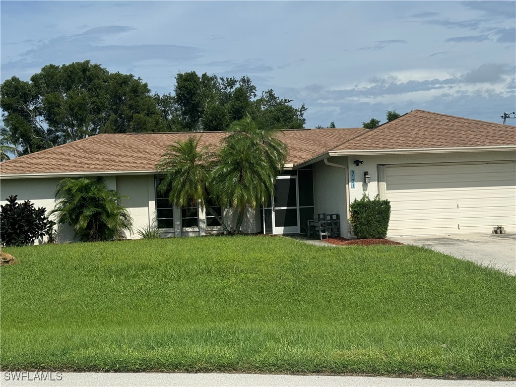 a front view of a house with a yard and trees