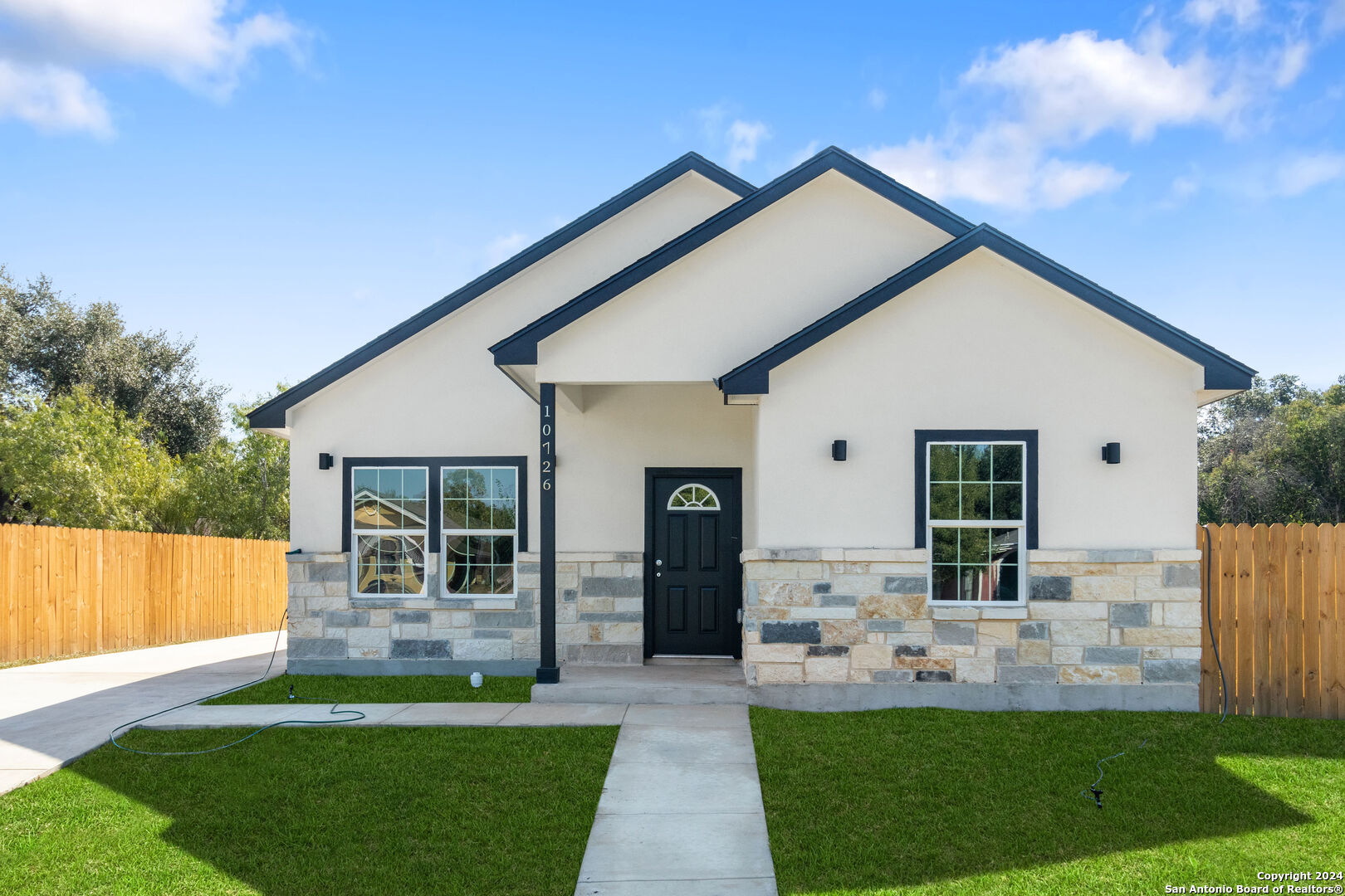 a front view of a house with a yard