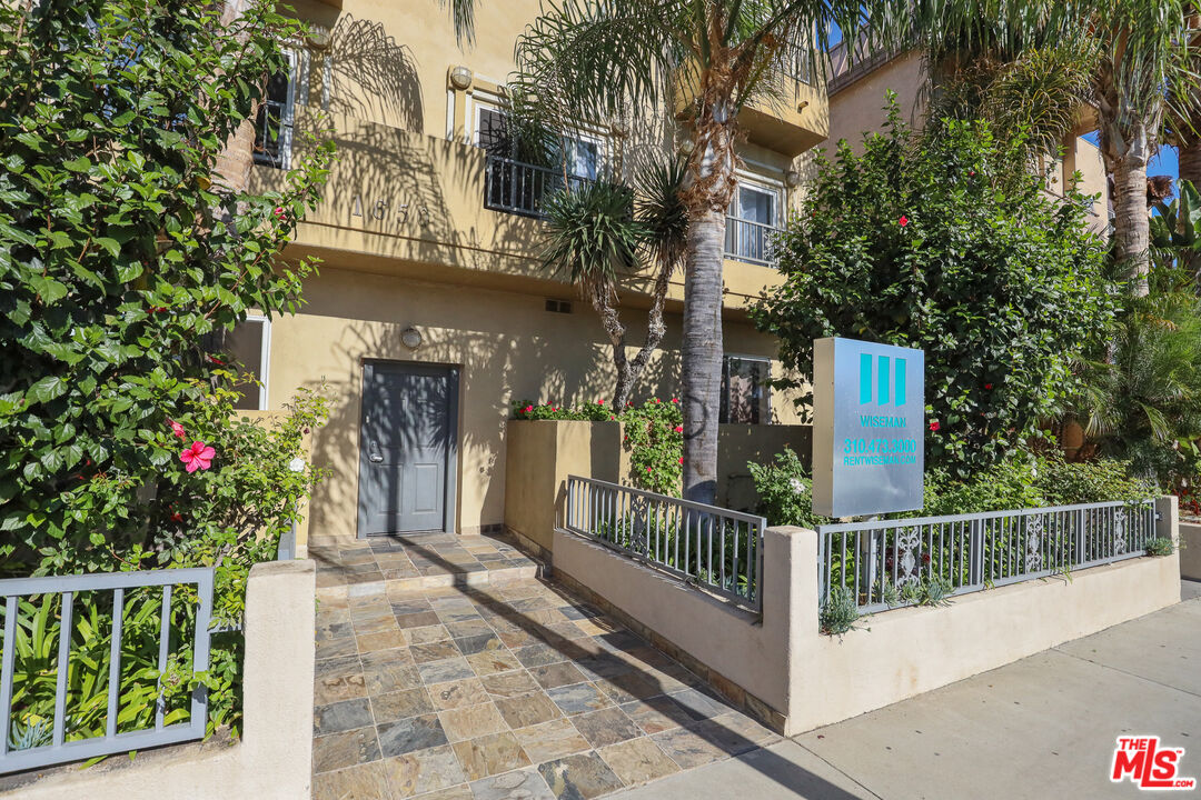 a view of a house with iron fence