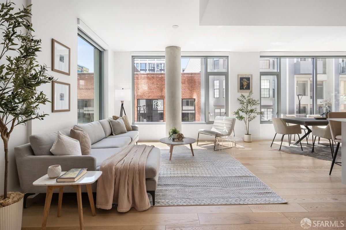 a living room with furniture and large windows