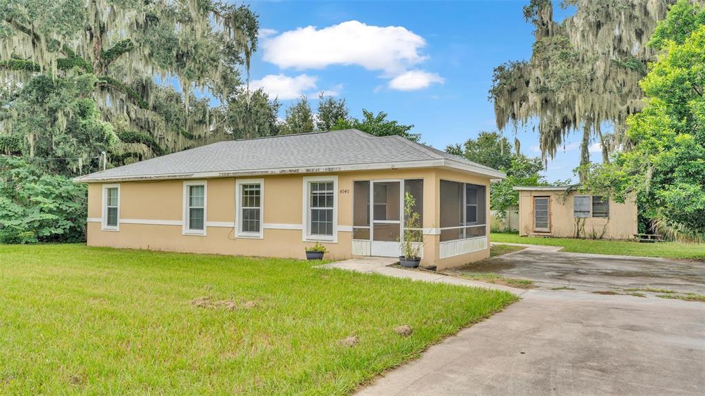 a view of a house with a yard and tree s