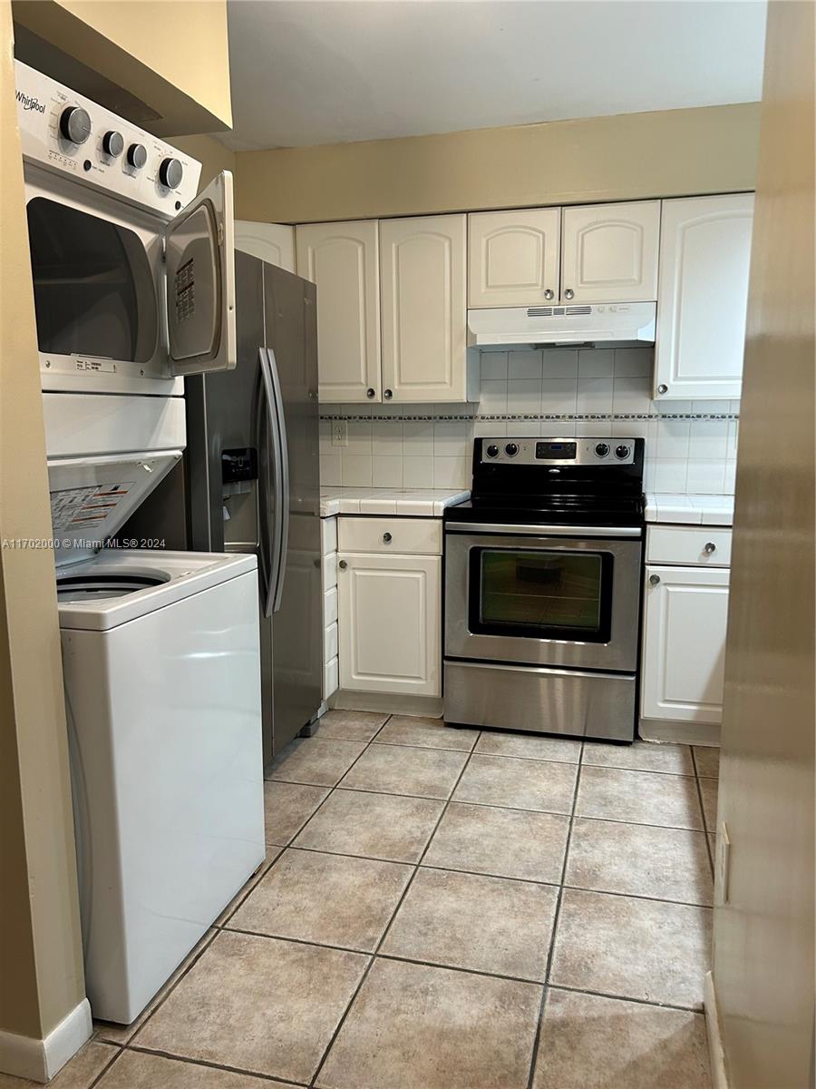 a kitchen with cabinets and appliances