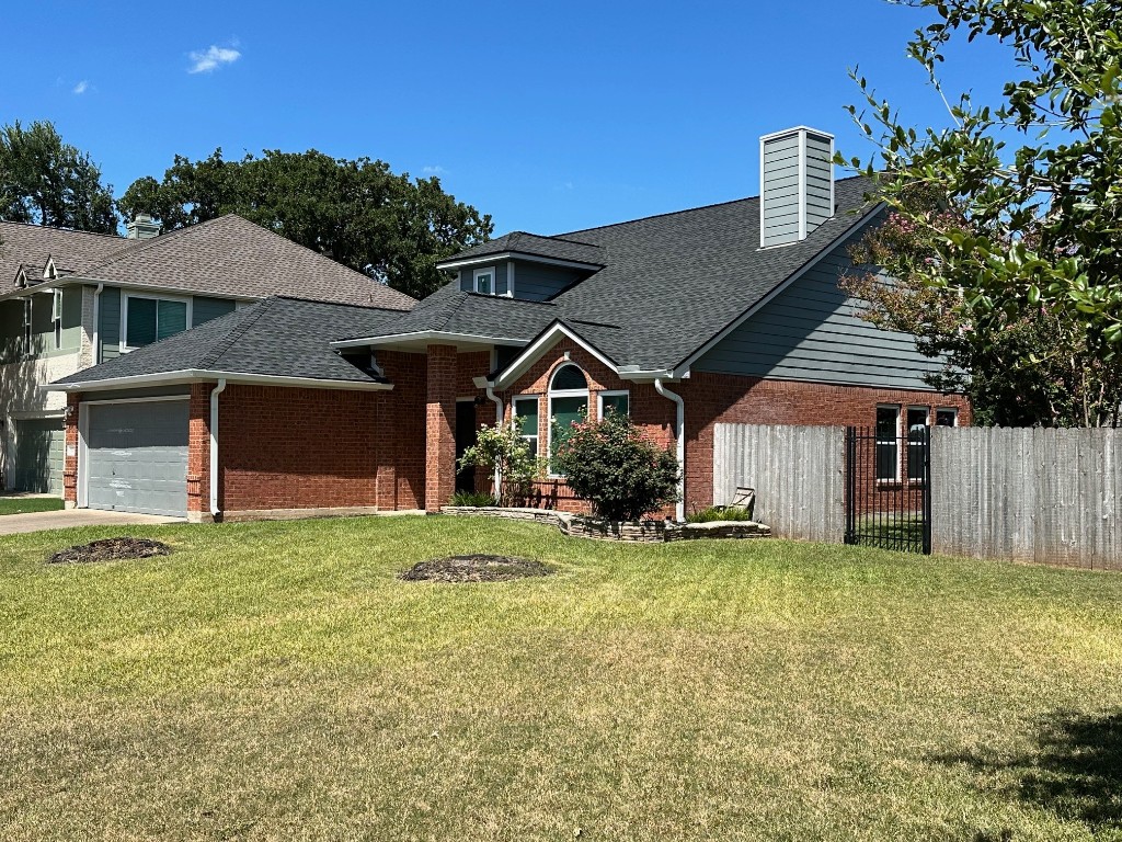 a view of a house with a yard and sitting area