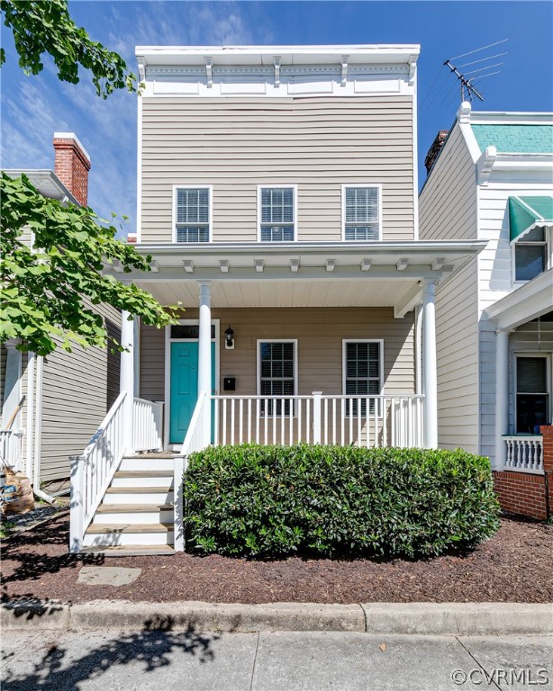 a front view of a house with a yard and potted plants