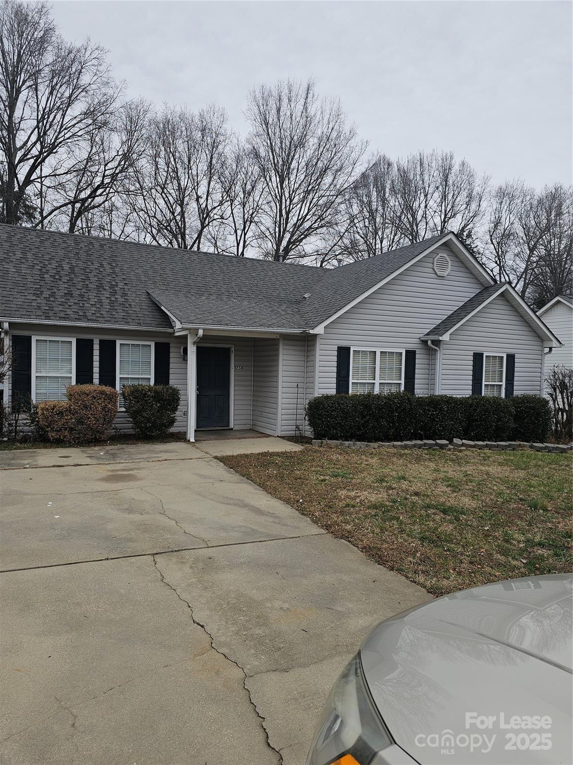 a front view of a house with garage and trees