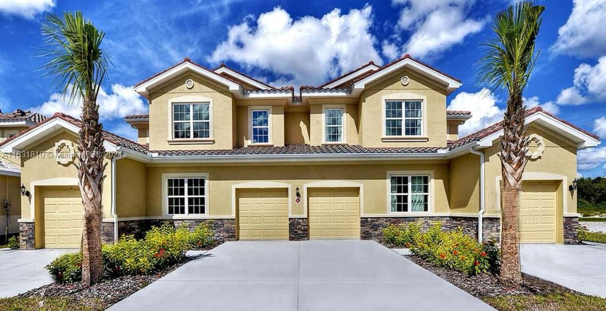 a front view of a house with a yard and garage