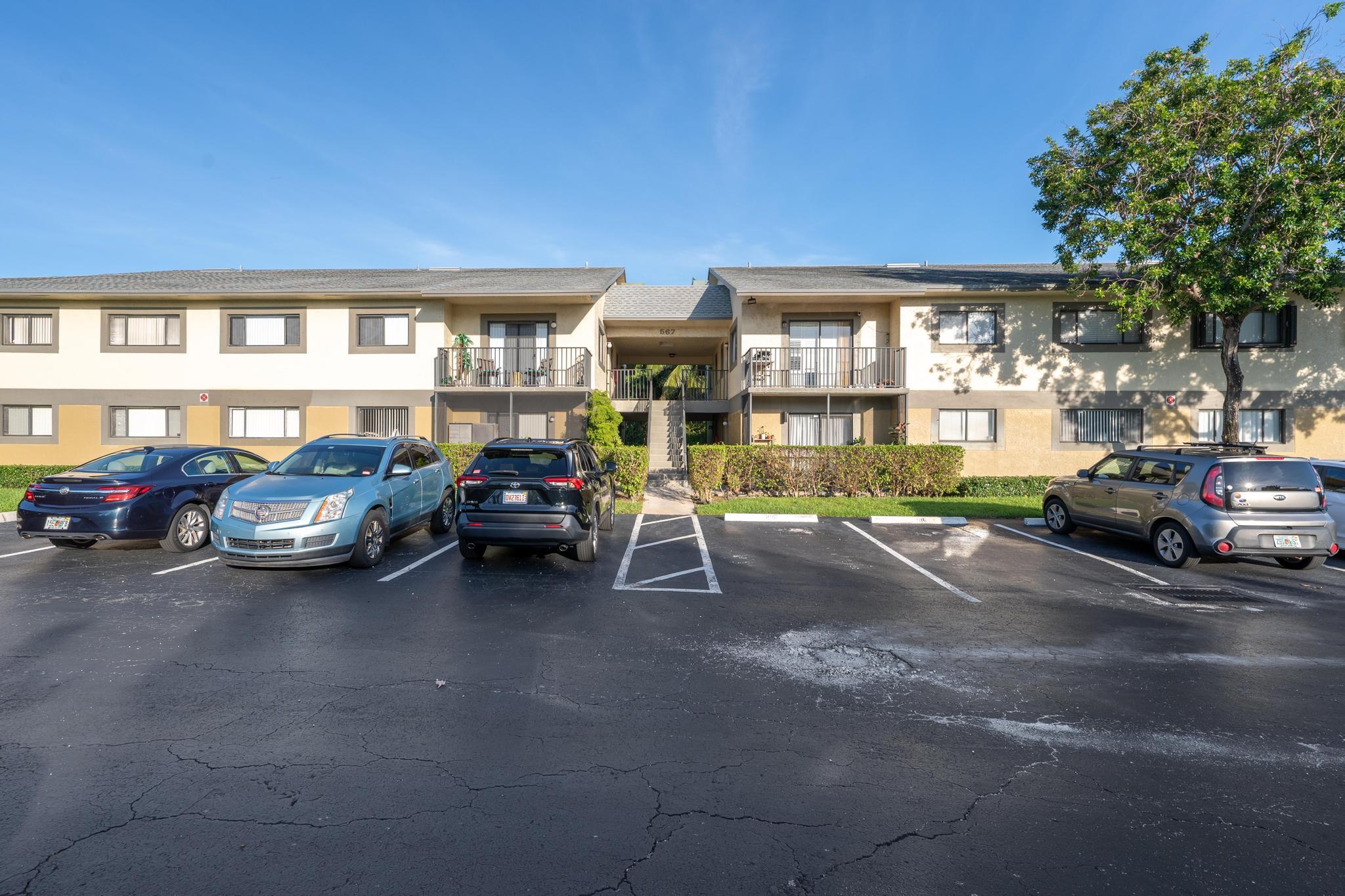 a view of a cars park in front of building