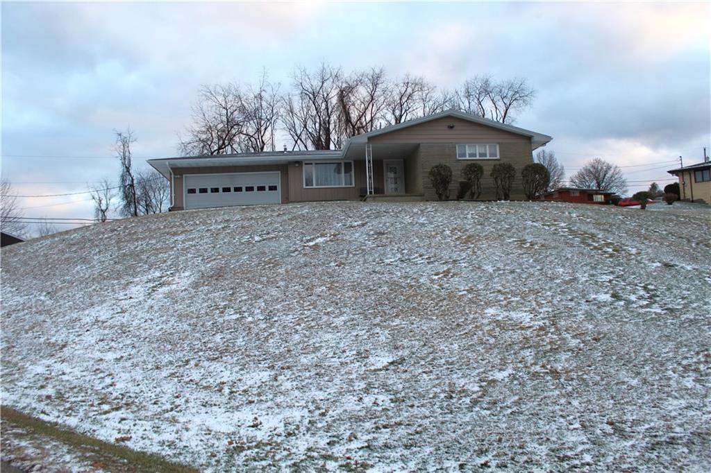 a view of a house with a yard and sitting area