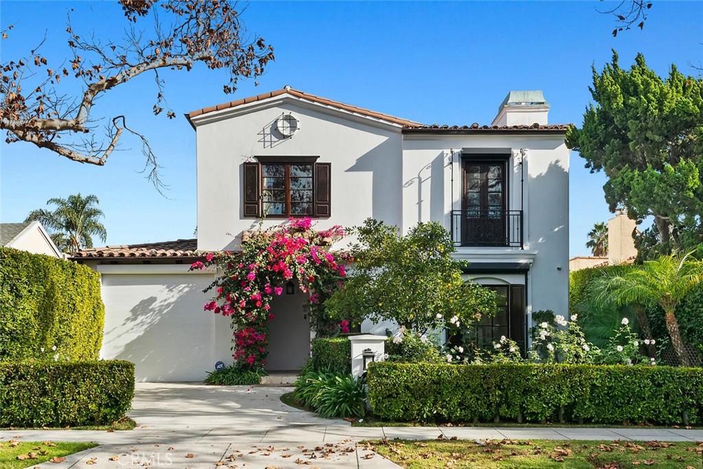 a front view of a house with plants