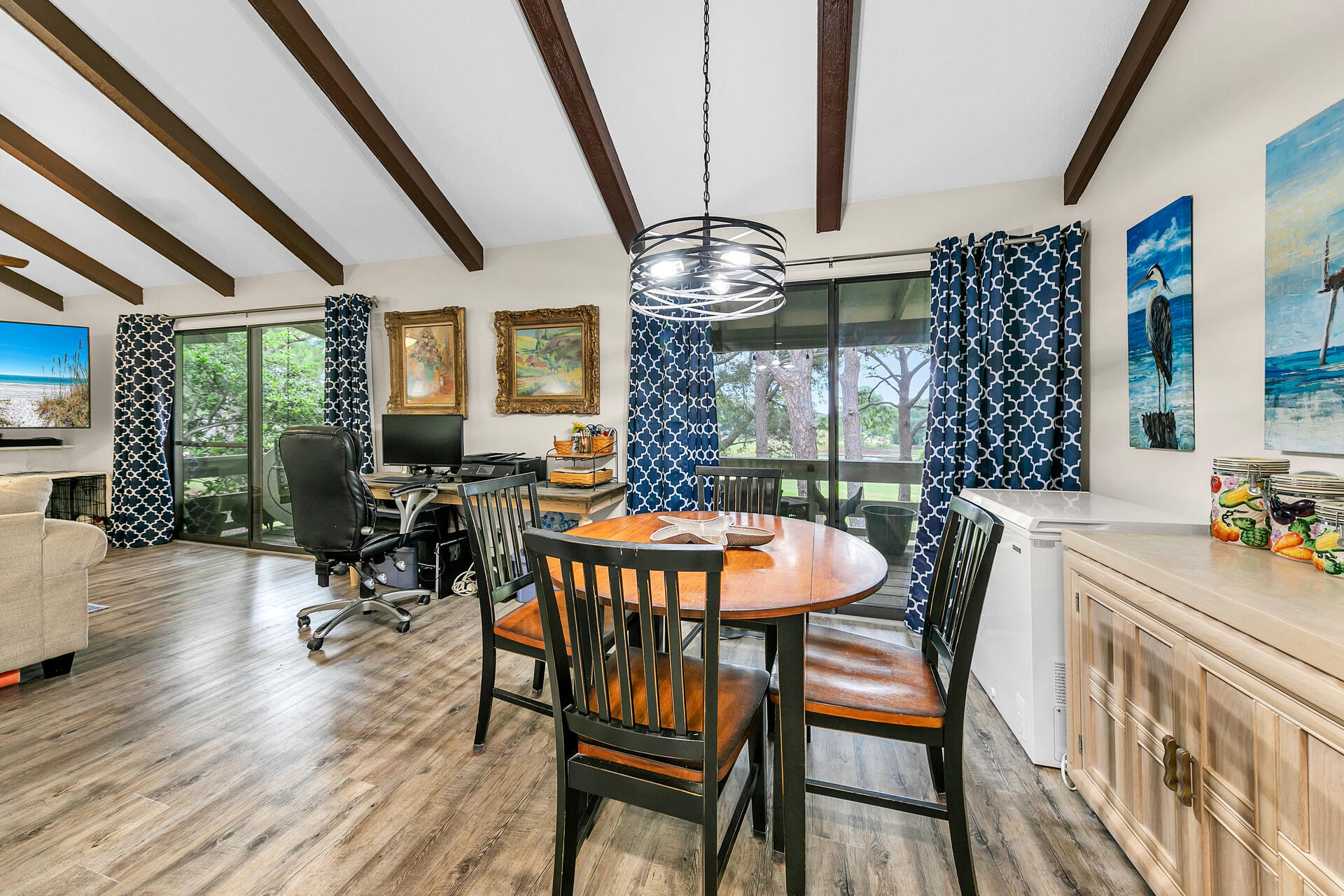 a dining room with furniture a chandelier and wooden floor