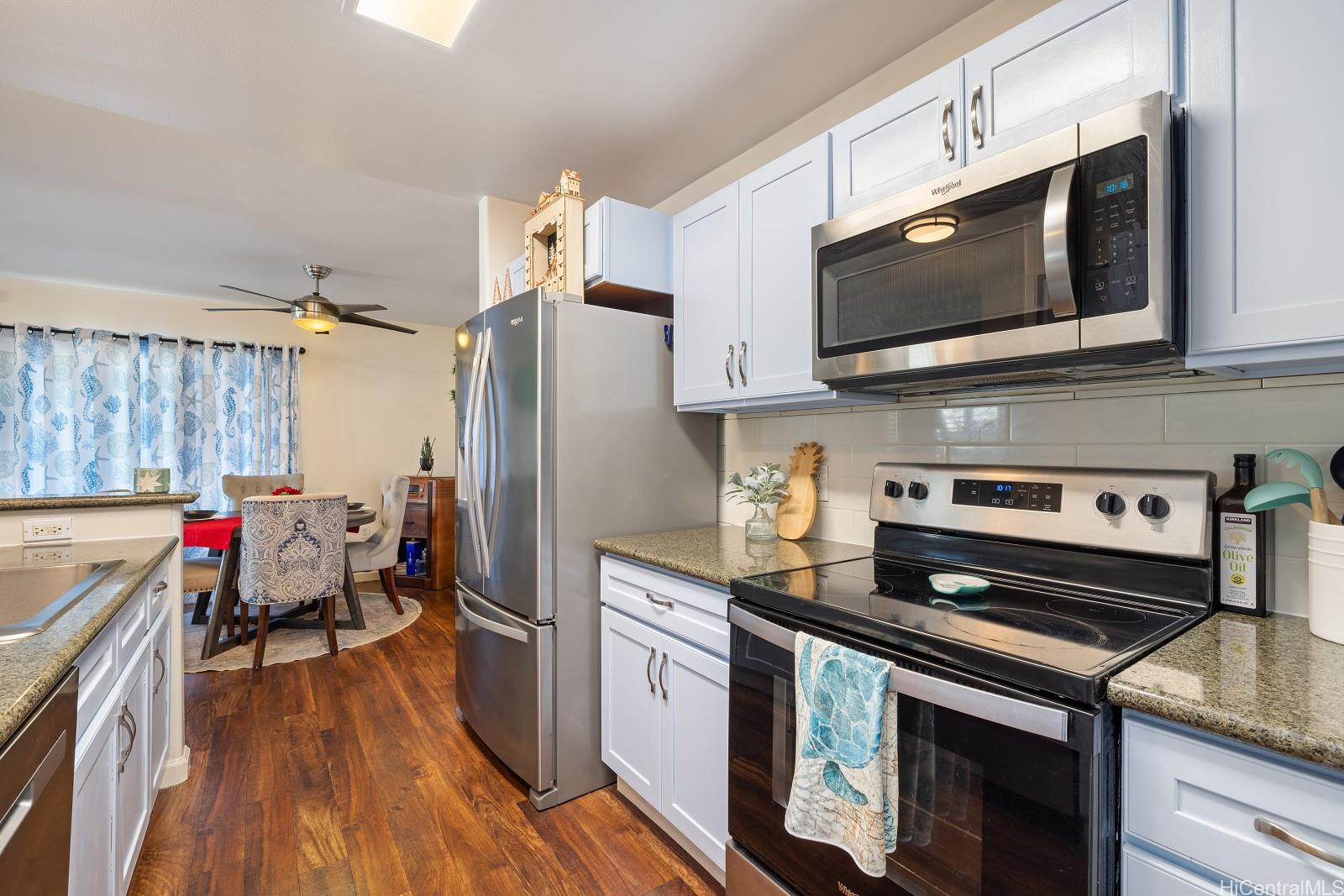 a kitchen with stainless steel appliances a stove microwave and cabinets