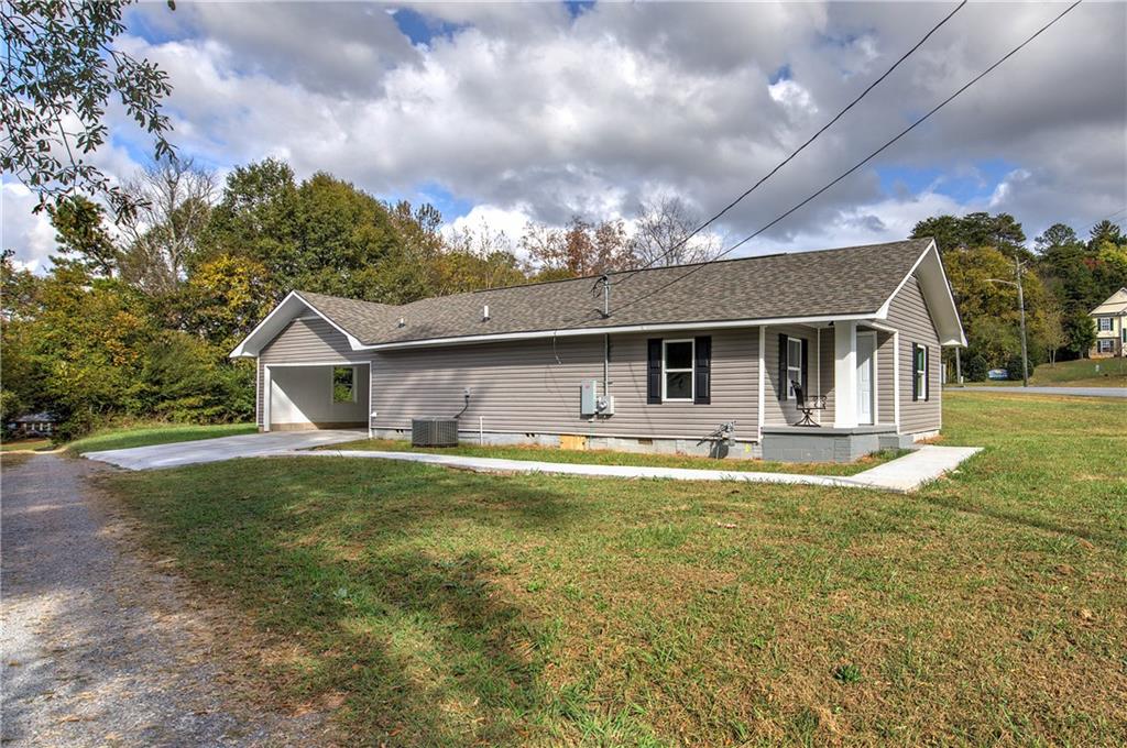 a front view of house with yard entertaining space and seating area